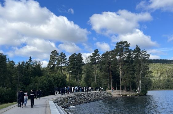 En gruppe mennesker som går langs en elv