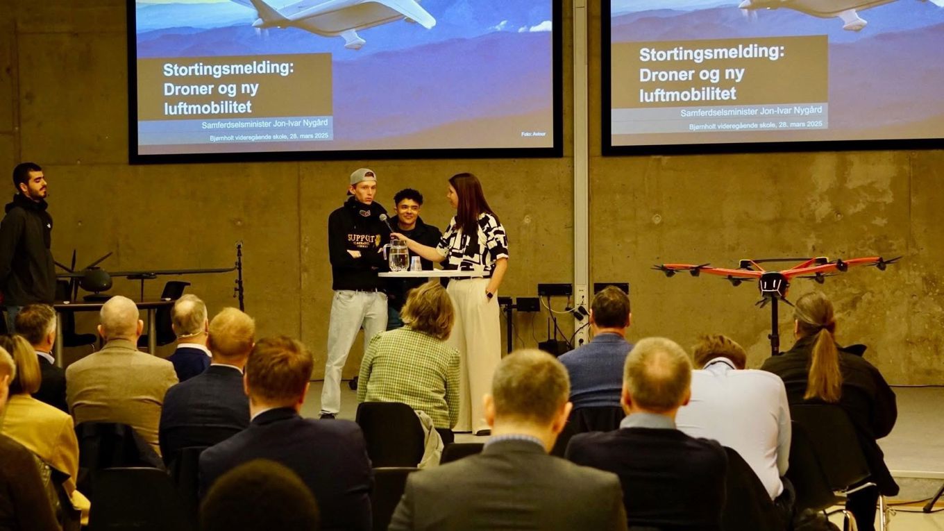 en person og person som står foran en folkemengde en person og person som står foran en folkemengde