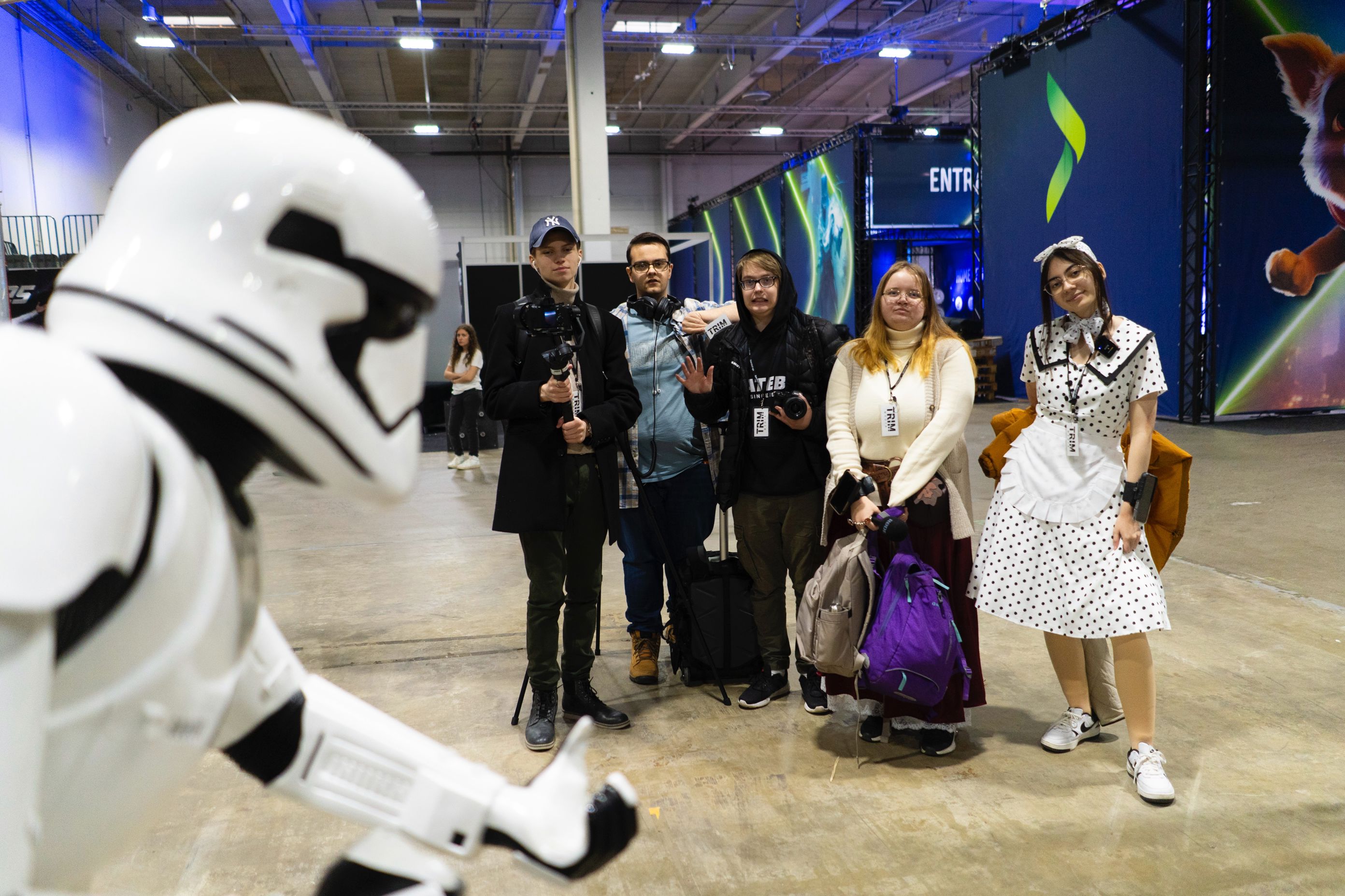 En gruppe mennesker som poserer for et bilde ved siden av en stor hvit robot